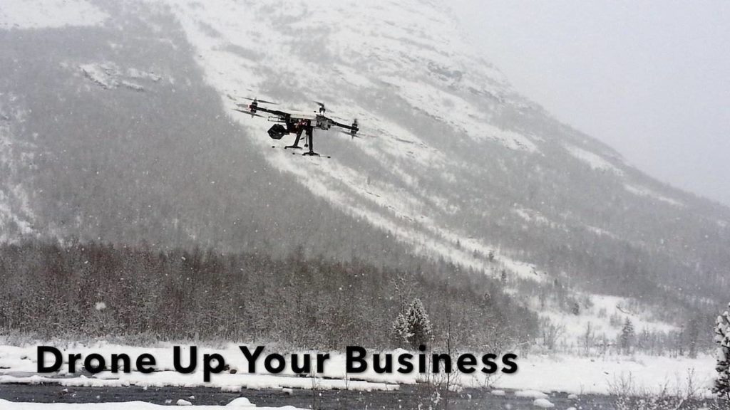 Photo of drone flying in the mountains indicating the use of commercial drones (UAVs, UAS, or quadcopters)